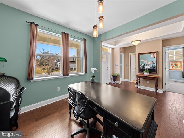 home office featuring baseboards and dark wood finished floors