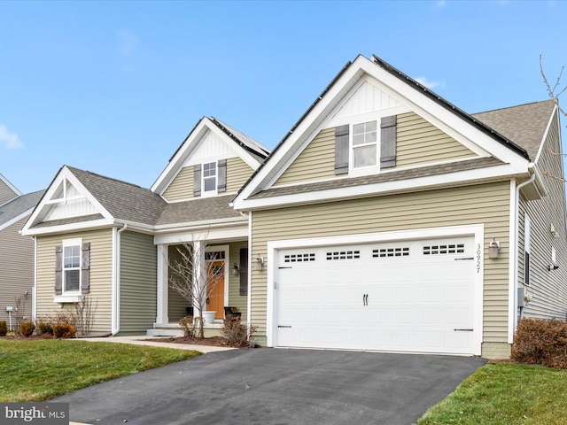 craftsman-style home with aphalt driveway and roof with shingles
