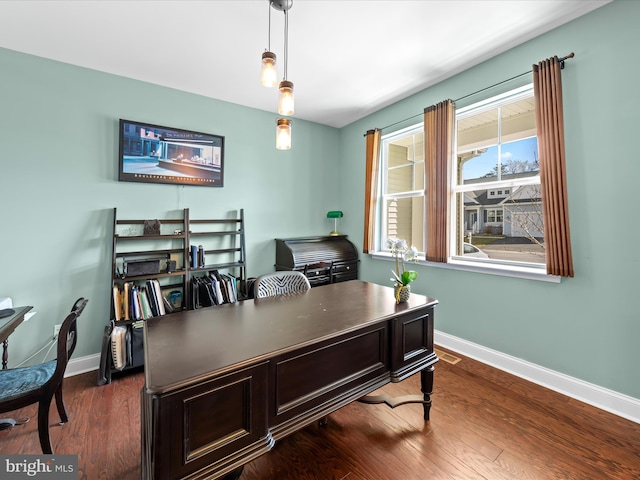 home office with visible vents, baseboards, and dark wood finished floors