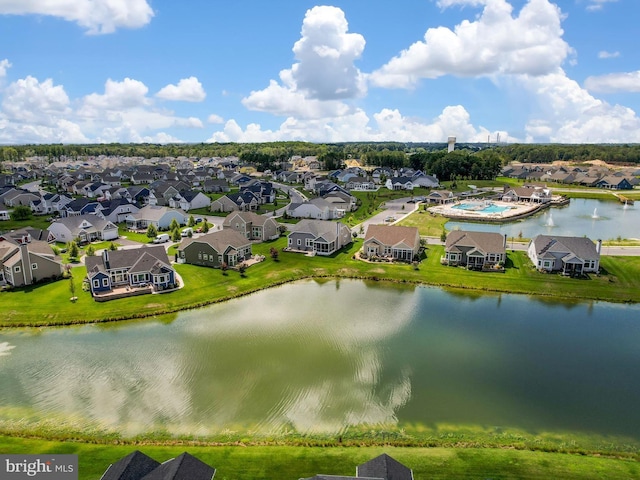 drone / aerial view featuring a residential view and a water view