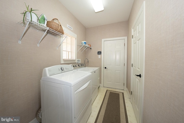 clothes washing area featuring laundry area and washing machine and dryer