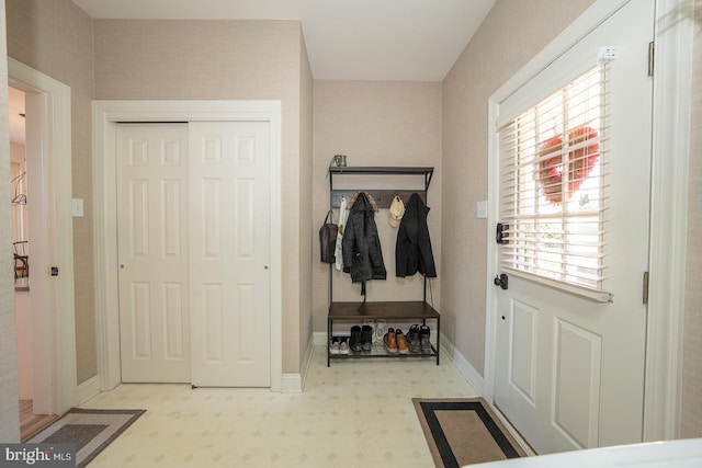 mudroom featuring light floors and baseboards