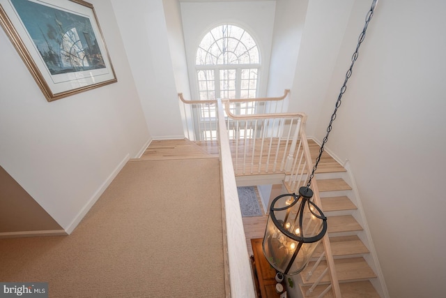 staircase with carpet and baseboards