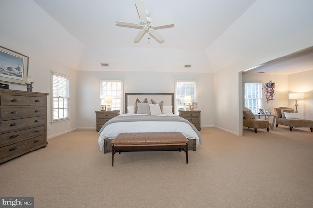 bedroom with light carpet, lofted ceiling, visible vents, and baseboards