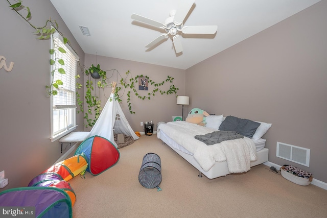 bedroom with carpet floors, baseboards, and visible vents