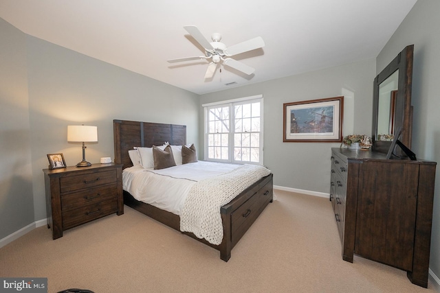 bedroom with a ceiling fan, light colored carpet, and baseboards