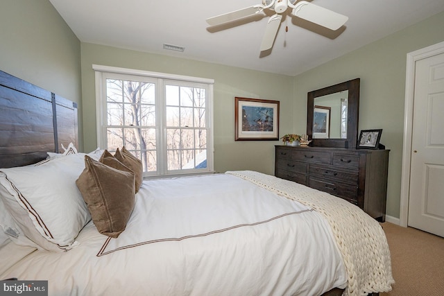 bedroom featuring ceiling fan, carpet flooring, and visible vents