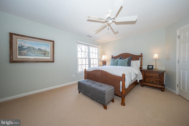 bedroom featuring a ceiling fan, light colored carpet, visible vents, and baseboards