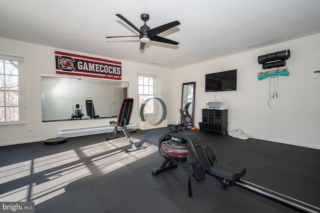 exercise room featuring ceiling fan, visible vents, and baseboards