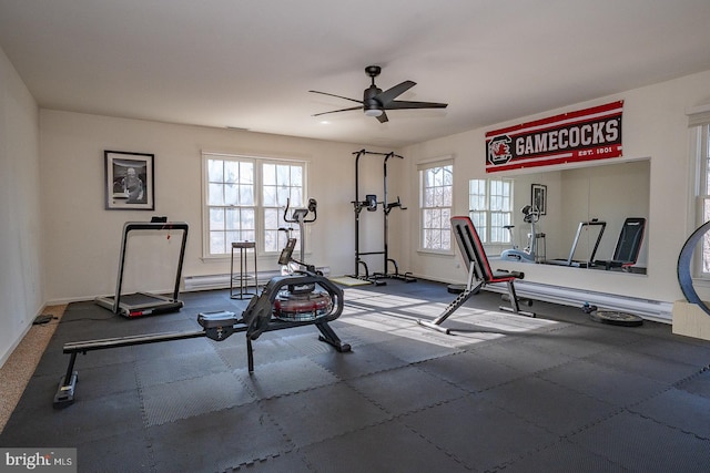 workout room with a ceiling fan and baseboards