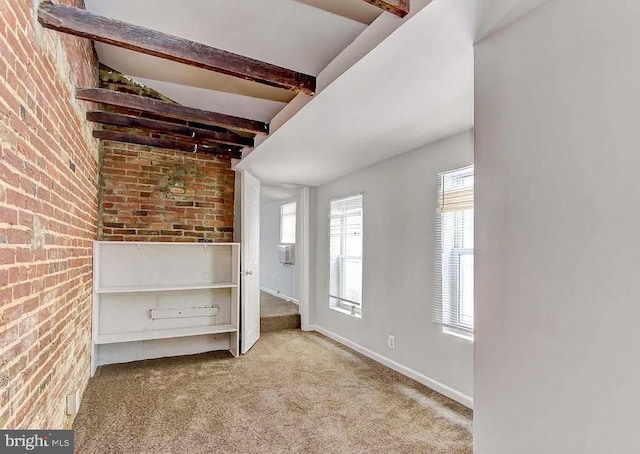 unfurnished bedroom with baseboards, brick wall, beamed ceiling, and light colored carpet