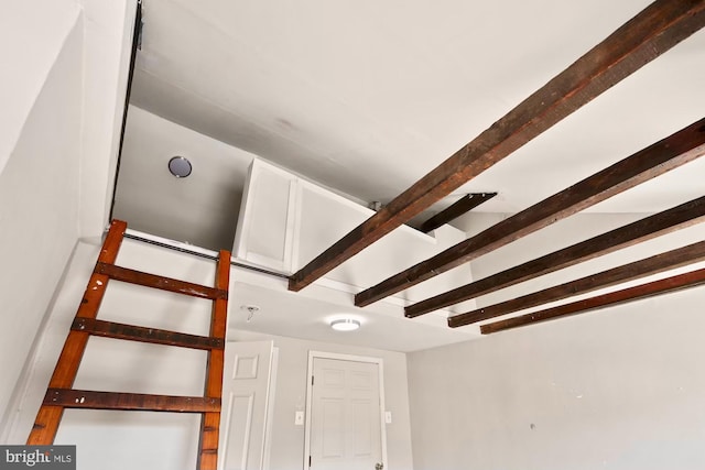 stairs featuring lofted ceiling with beams