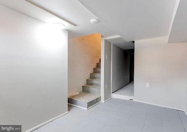 finished basement with baseboards and stairs