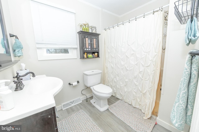 full bath with toilet, wood finished floors, vanity, visible vents, and ornamental molding