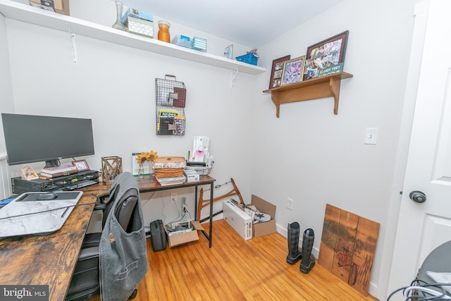 office space featuring baseboards and wood finished floors