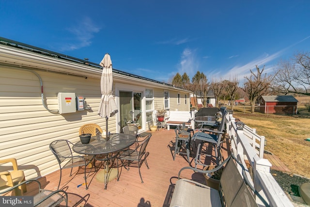 deck with outdoor dining area