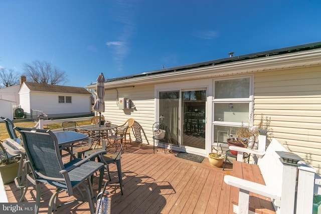 wooden terrace featuring outdoor dining area