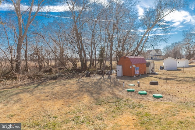 view of yard featuring an outbuilding and a storage shed