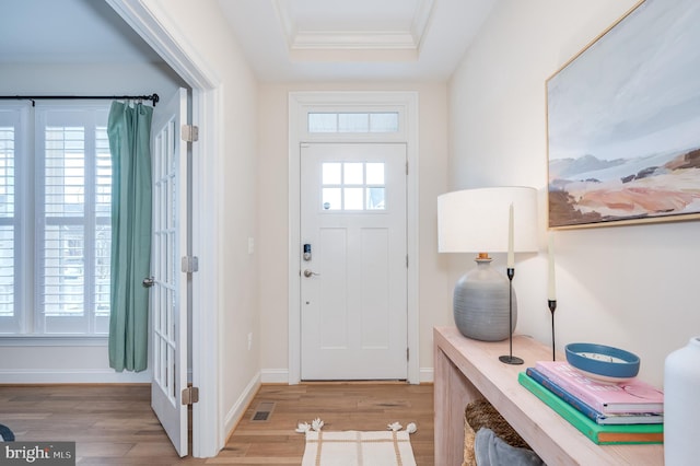 entryway with plenty of natural light, wood finished floors, and visible vents