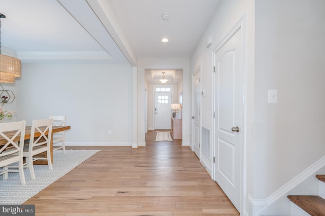 foyer with stairs, recessed lighting, light wood-style flooring, and baseboards