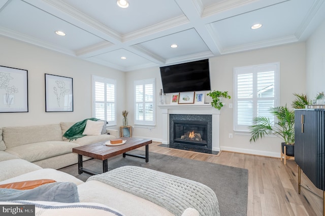 living area with coffered ceiling, a fireplace with flush hearth, wood finished floors, baseboards, and beamed ceiling