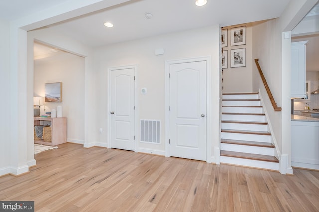 foyer entrance with recessed lighting, visible vents, stairway, light wood-style flooring, and baseboards