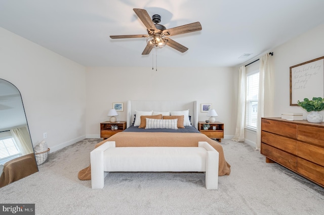 bedroom with light carpet, ceiling fan, and baseboards