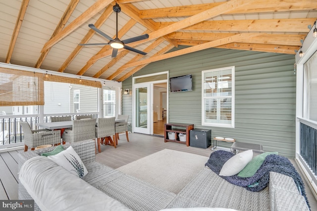 interior space with vaulted ceiling, wood finished floors, and a ceiling fan