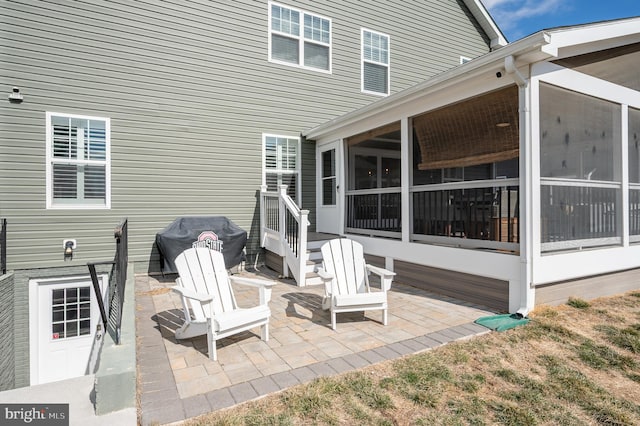 view of patio / terrace with area for grilling and a sunroom