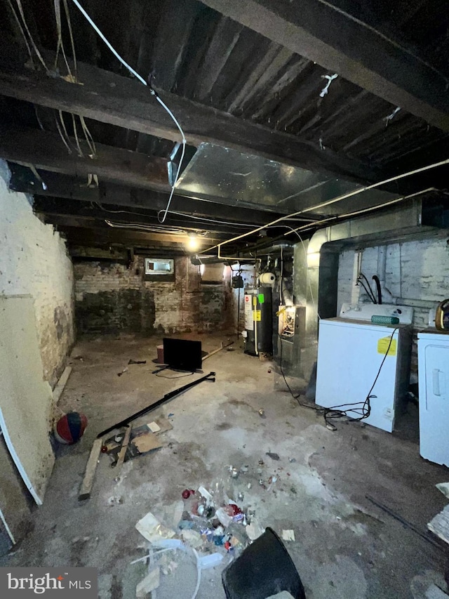 unfinished below grade area featuring washer / clothes dryer and gas water heater