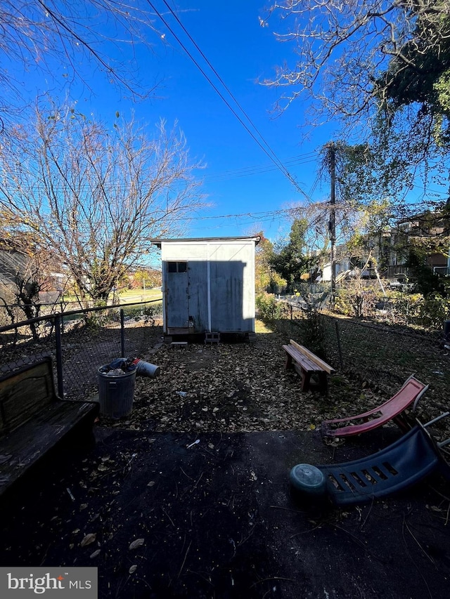 exterior space featuring fence, an outdoor structure, and a storage shed