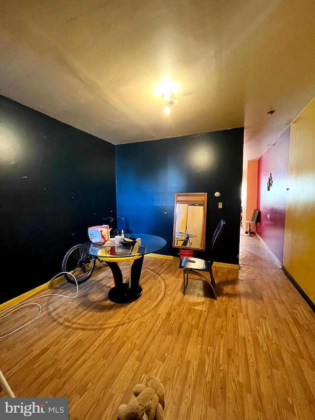 dining area featuring light wood-type flooring and baseboards