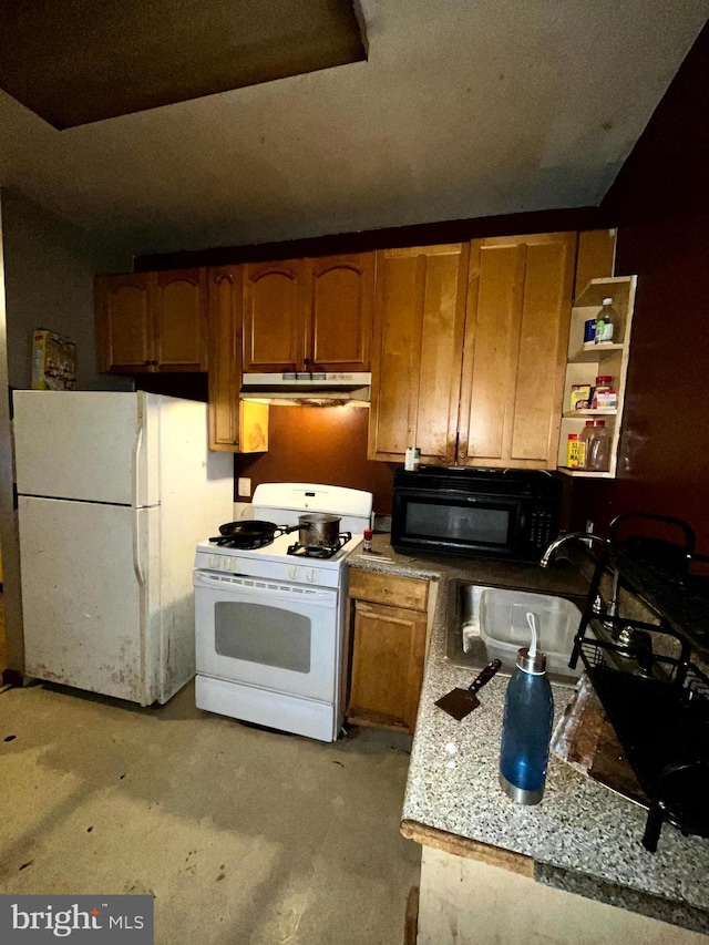 kitchen with white appliances, brown cabinets, a sink, and under cabinet range hood