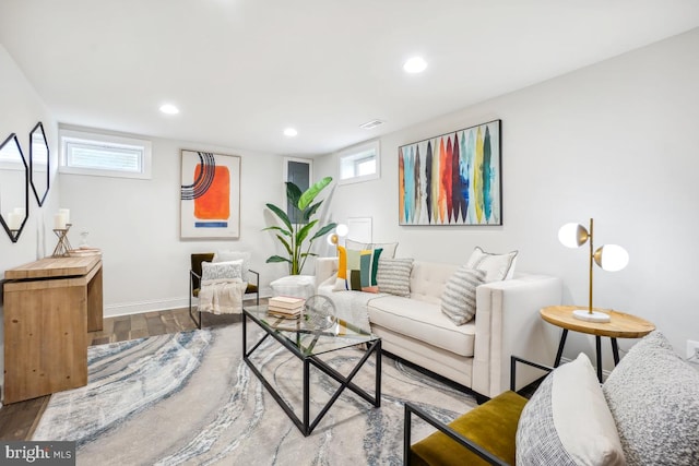 living room with plenty of natural light, wood finished floors, and recessed lighting