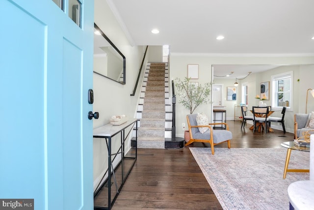 entrance foyer with crown molding, recessed lighting, dark wood-type flooring, baseboards, and stairs