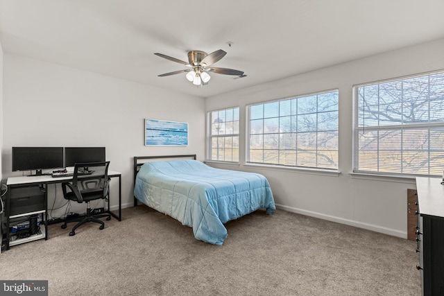 carpeted bedroom featuring a ceiling fan and baseboards