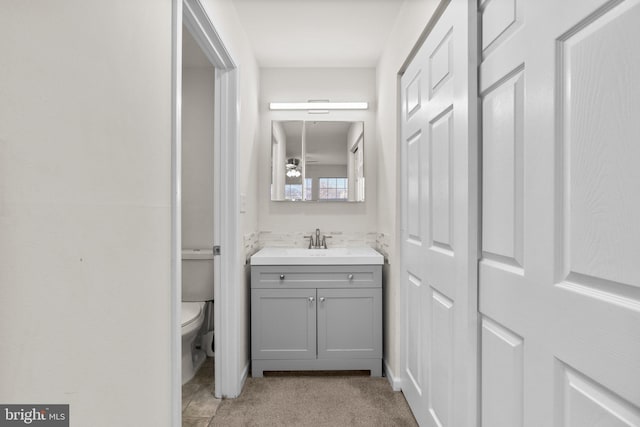 bathroom featuring toilet and vanity