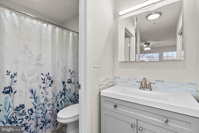 bathroom with decorative backsplash, toilet, vanity, and a ceiling fan