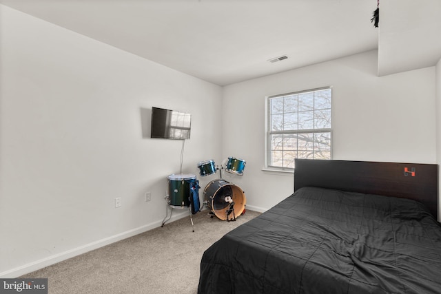 bedroom featuring visible vents, carpet, and baseboards