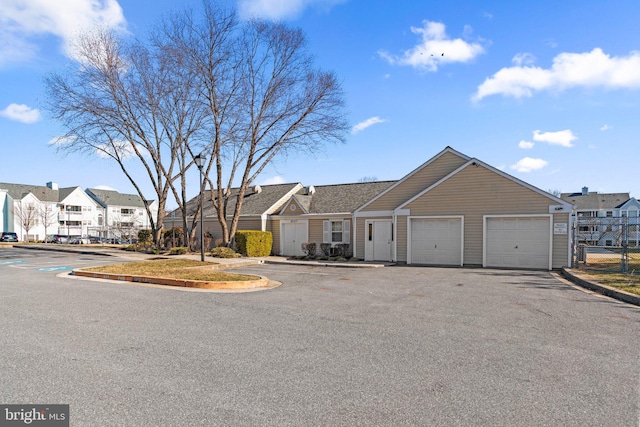 view of front of property with a residential view and fence