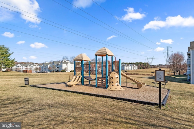 community jungle gym featuring a yard