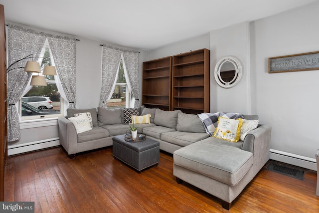 living room featuring a wealth of natural light, baseboard heating, hardwood / wood-style floors, and a baseboard radiator