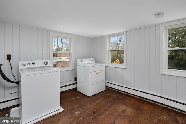 laundry room featuring laundry area, washing machine and dryer, baseboard heating, and dark wood-style flooring