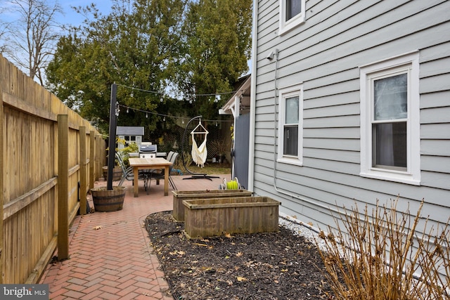 view of yard featuring outdoor dining area, a patio, and a fenced backyard