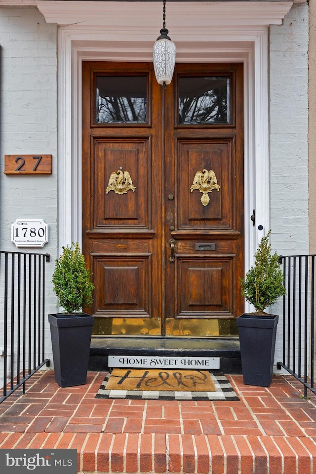 view of exterior entry with brick siding