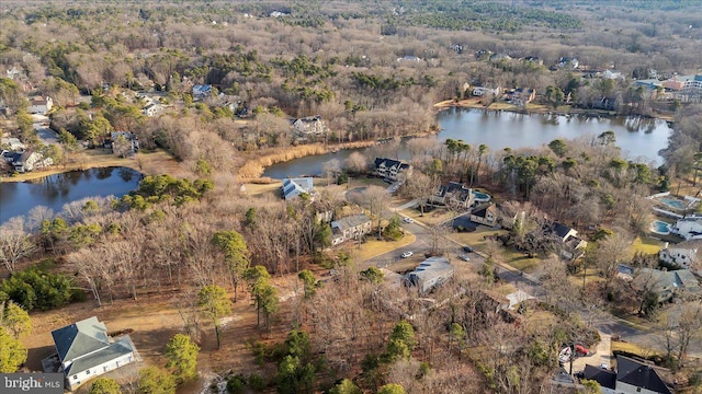 drone / aerial view featuring a forest view and a water view