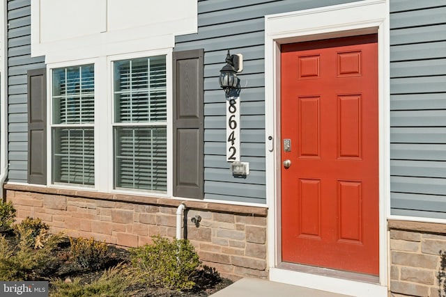 entrance to property featuring stone siding