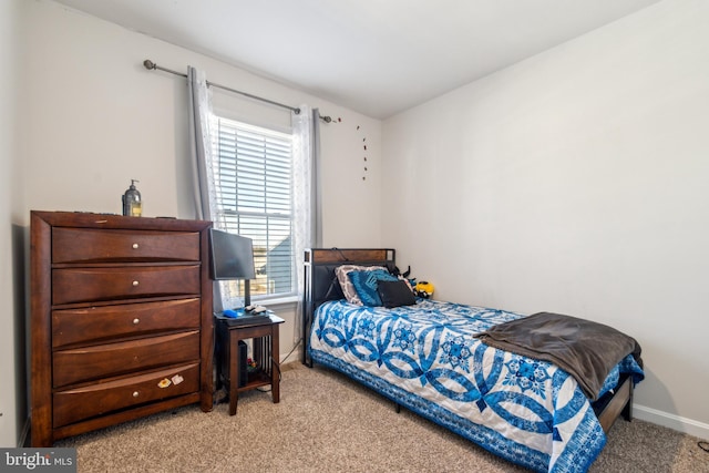 bedroom featuring baseboards and light colored carpet