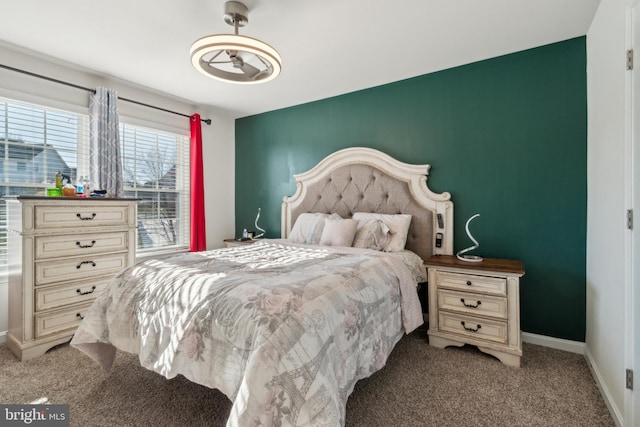 bedroom with light carpet and baseboards