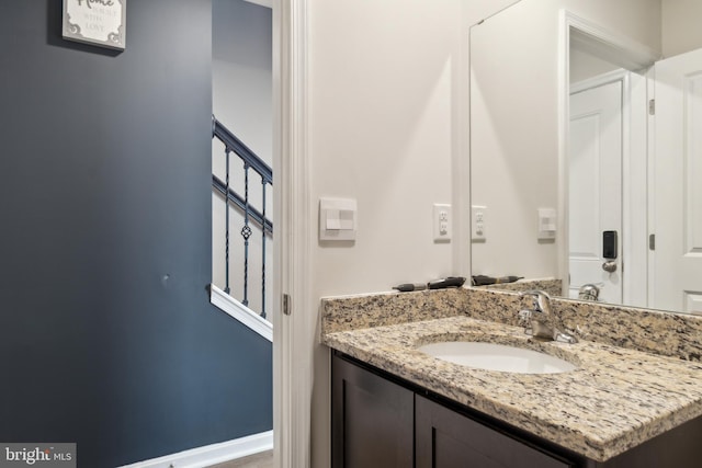 bathroom with vanity and baseboards